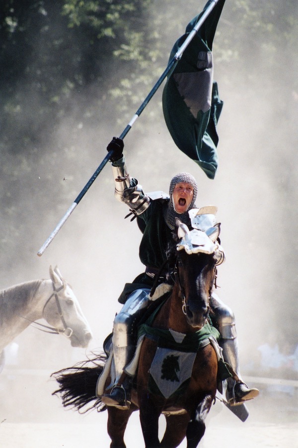 Knight on horseback charging with a flag, screaming